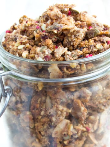 An open glass jar filled with keto granola.