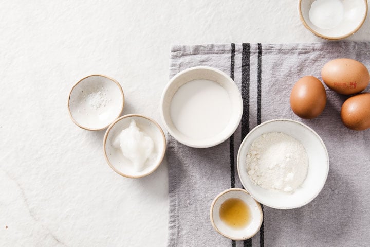 eggs, coconut flour and other ingredients for pancakes in bowls