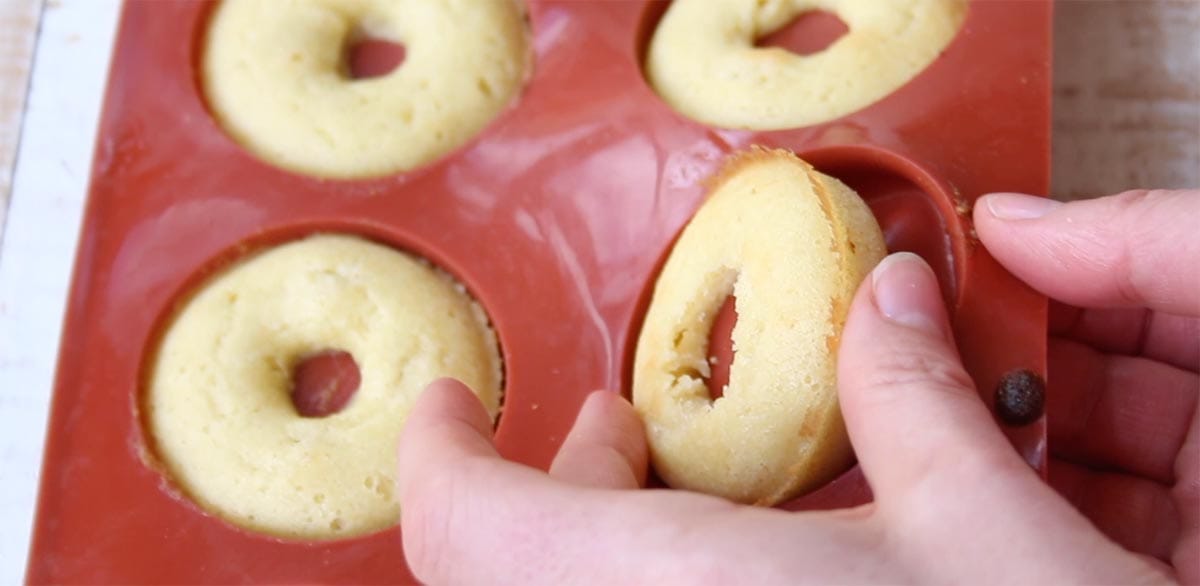 releasing a donut out of a silicone donut pan