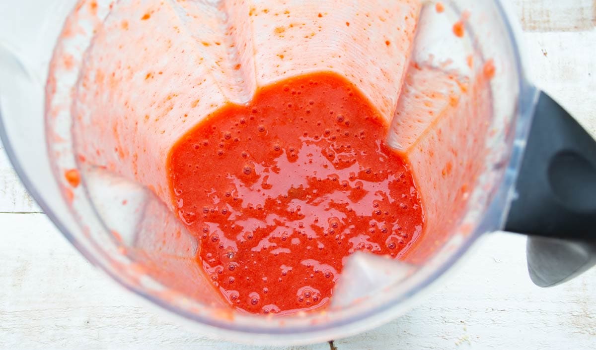 blended strawberries in a blender jug