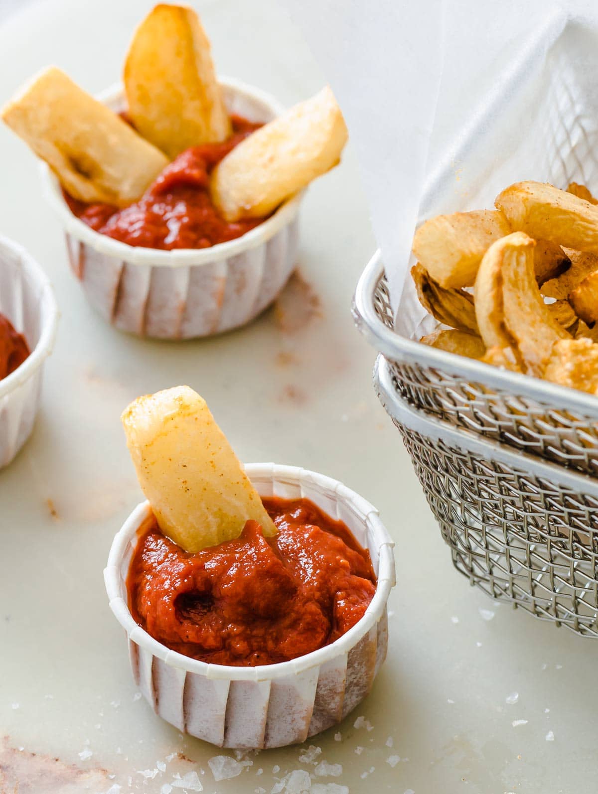 paper cups filled with keto ketchup and turnip fries stuck into it