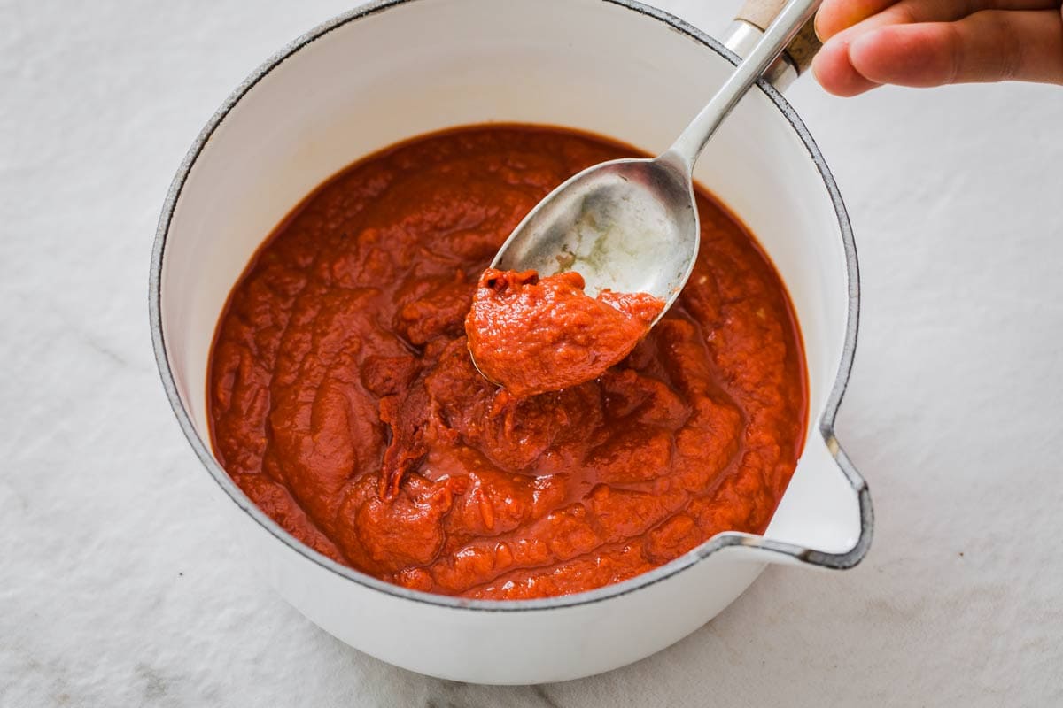 ketchupa saucepan with ketchup and a spoon