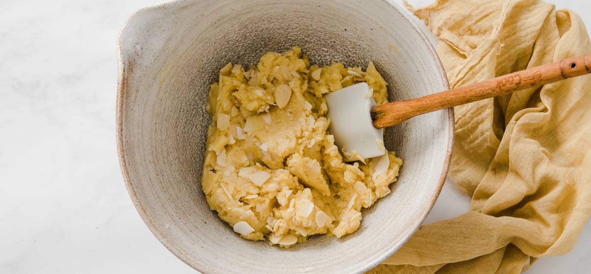 Cookie dough in a bowl with a spatula.