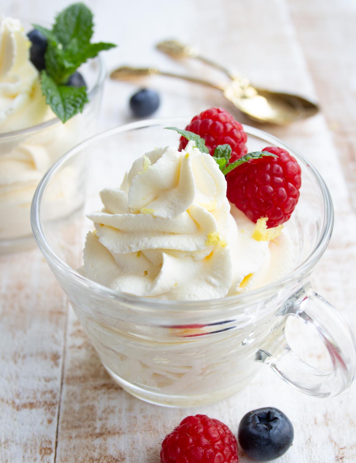 keto cheesecake fluff in a glass cup decorated with berries