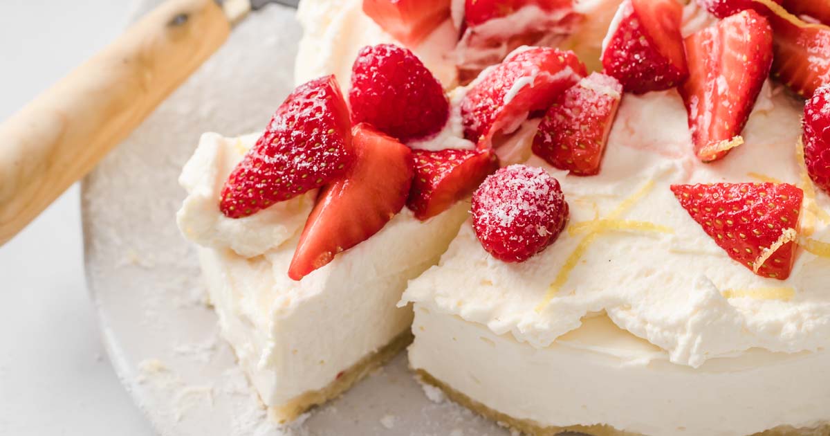 a slice of low carb cheesecake topped with strawberries and raspberries