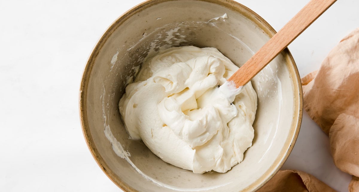 folding whipped cream into the cream cheese mix with a spatula