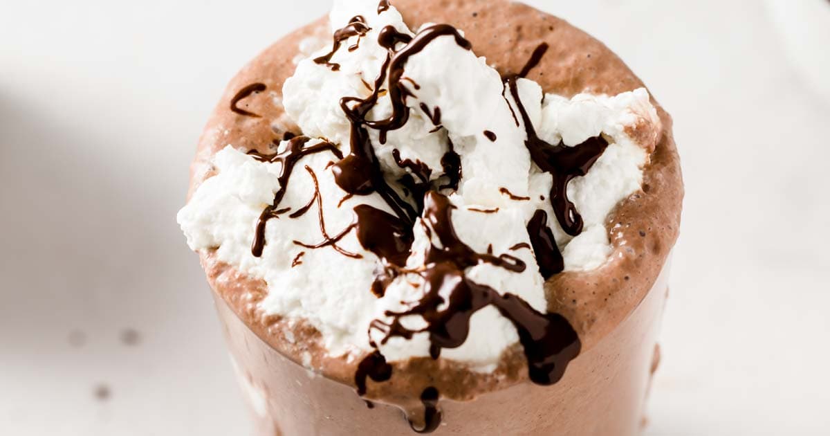 a chocolate milkshake topped with whipped cream and melted chocolate