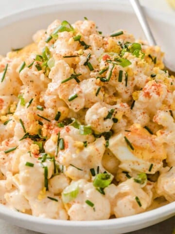 keto cauliflower "potato" salad topped with chopped chives
