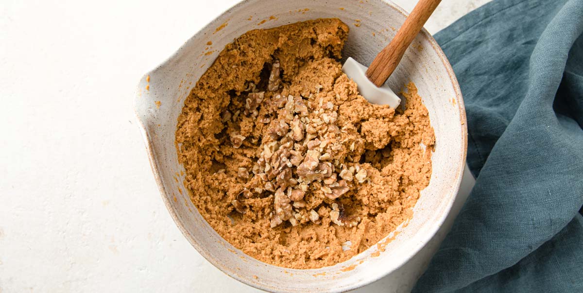 Adding walnuts to the batter. 