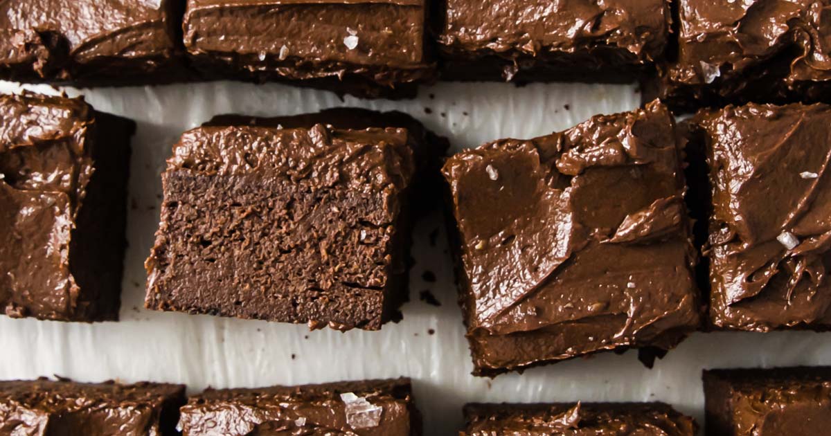 brownie squares with frosting and one lying on the side