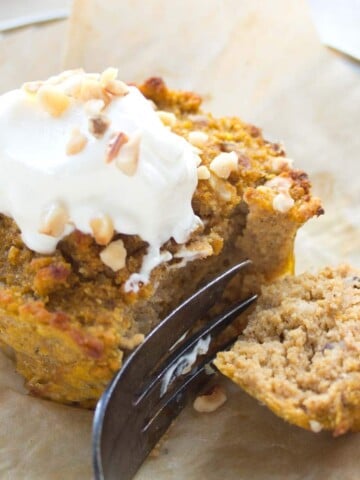 a keto pumpkin muffin with sour cream frosting