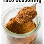 glass jar with keto taco seasoning and a spoon