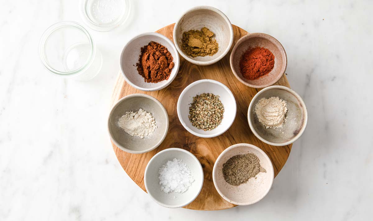 spices in bowls and a glass jar