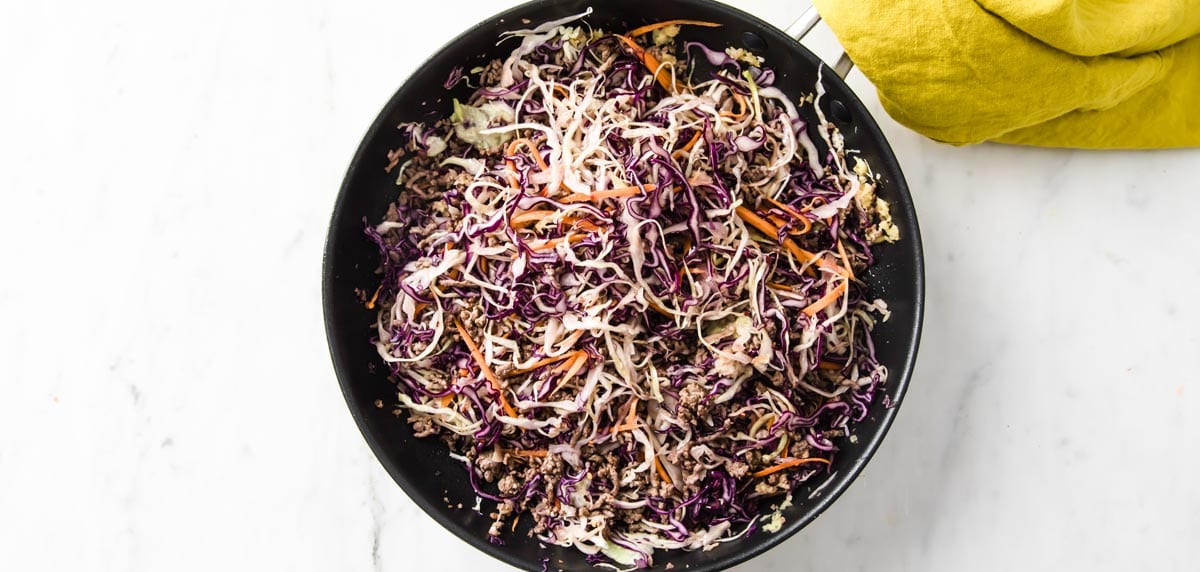 shredded slaw and fried ground beef in a saucepan