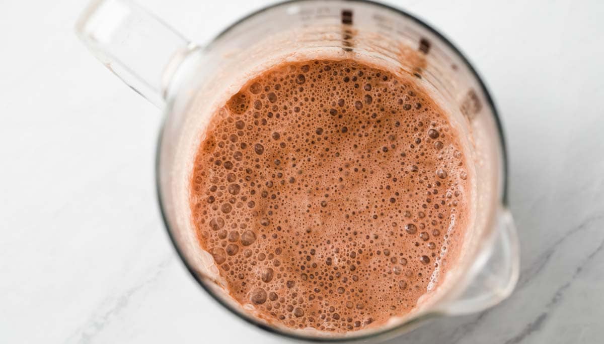 Frothy chocolate milk in a jug.