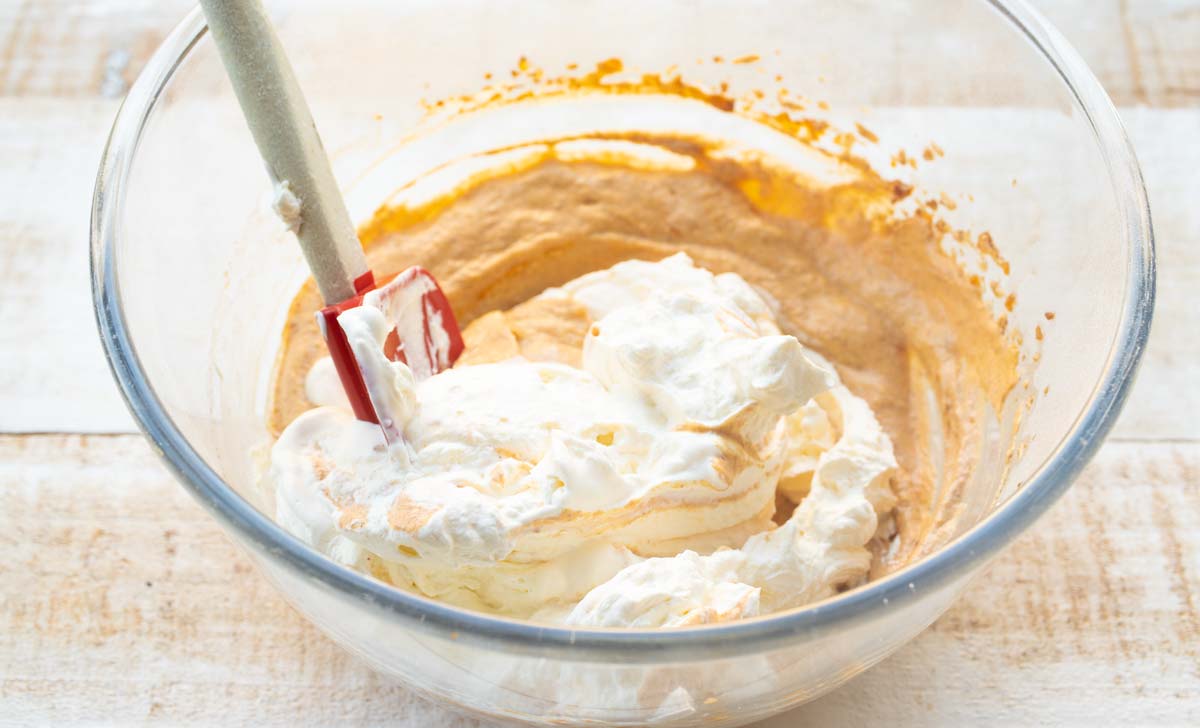 Pumpkin mix and whilled cream folded in with a spatula.