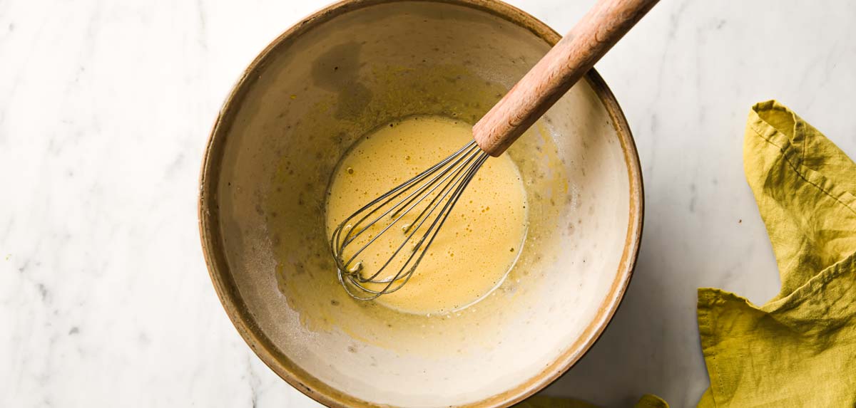 preparing sugar free eggnog: whisking the egg yolks and sweetener in a bowl
