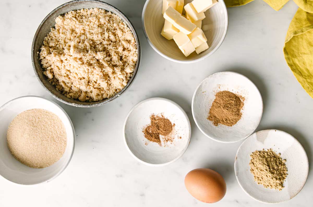 nut flour, butter, egg and spices measured out in bowls