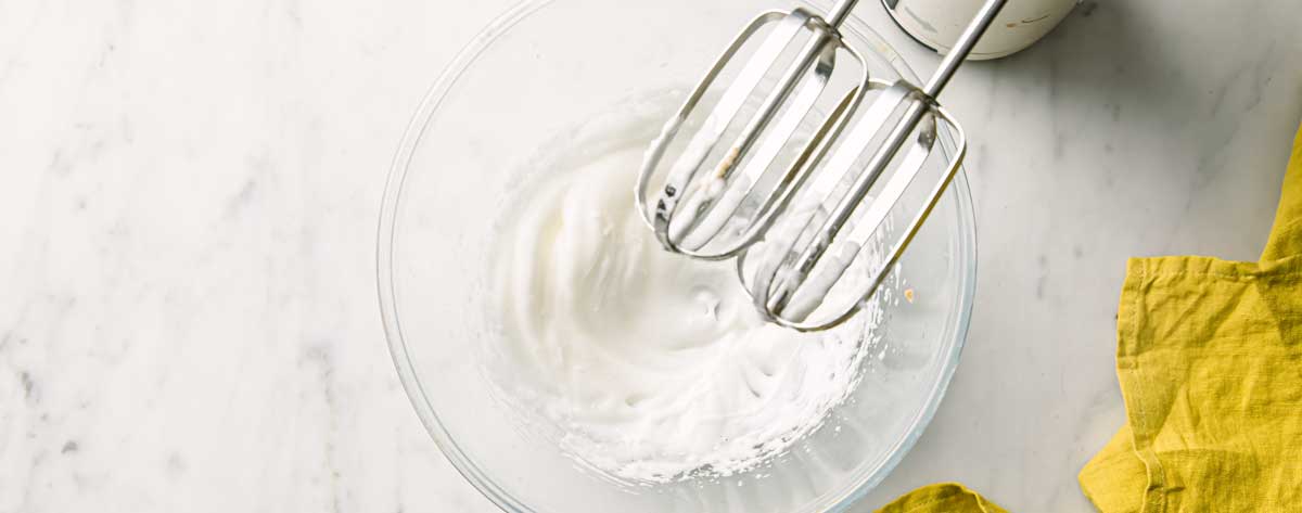 whipping egg whites until stiff with an electric bleder