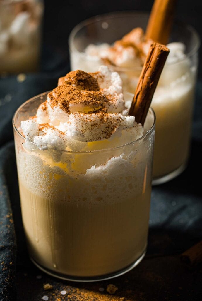 a glass with sugar free eggnog topped with frothy egg white and nutmeg
