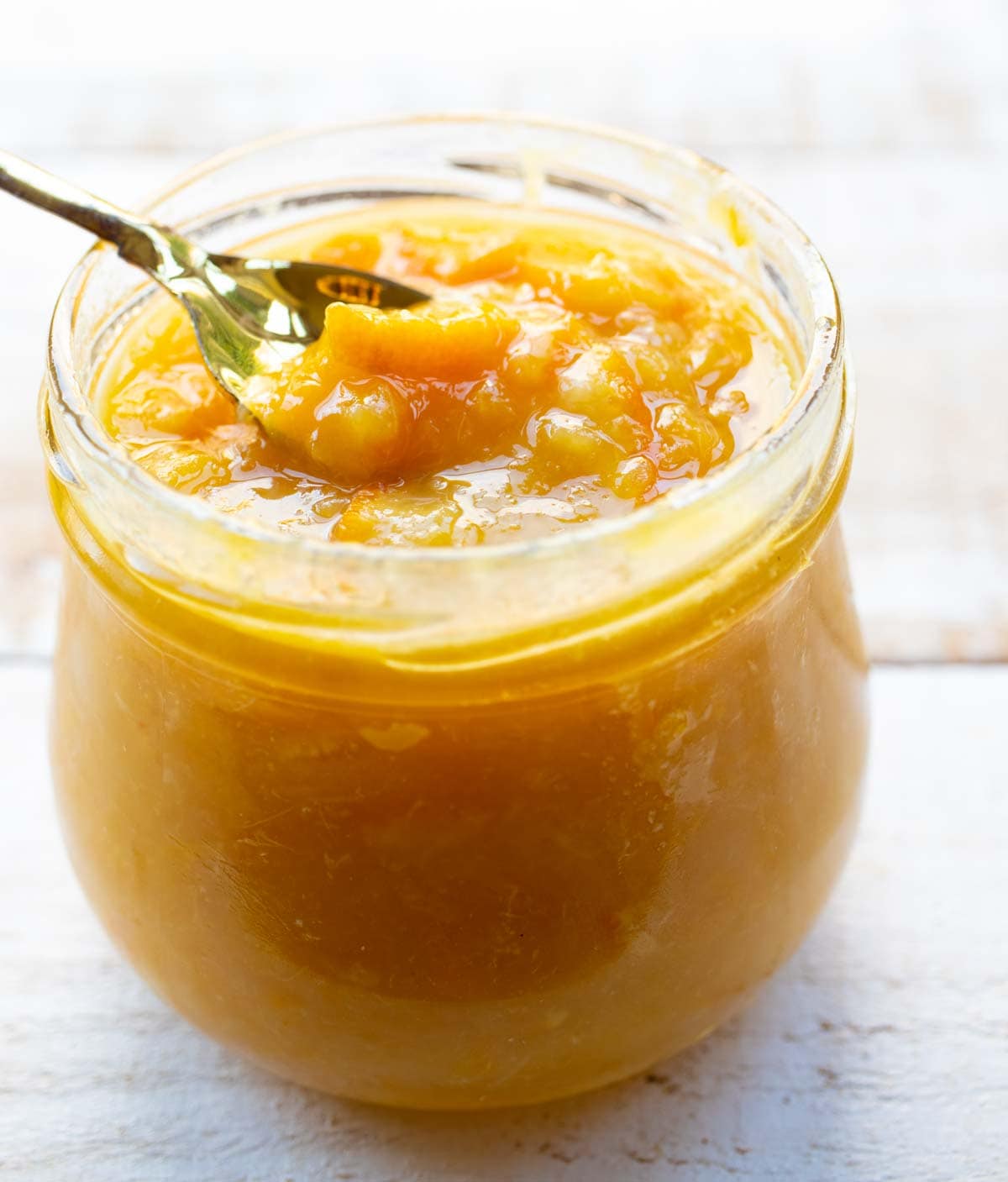 a glass jar of sugar free orange marmalade with a spoon