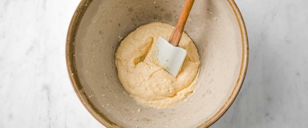 mixing batter for madeleines with a spatula