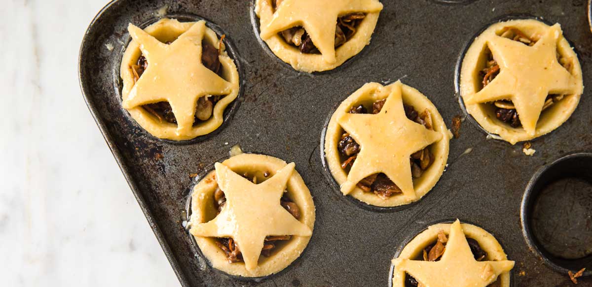 unbaked mince pies in a baking pan