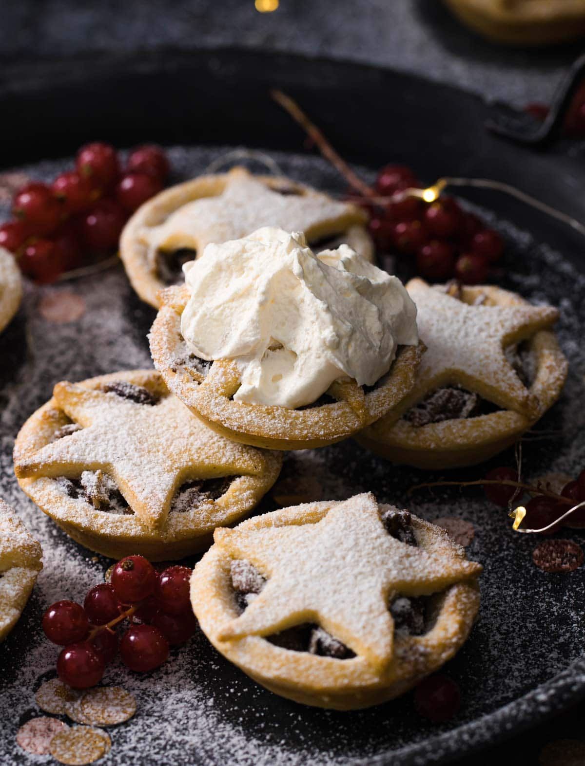 sugar free mince pies stacked, one topped with cream