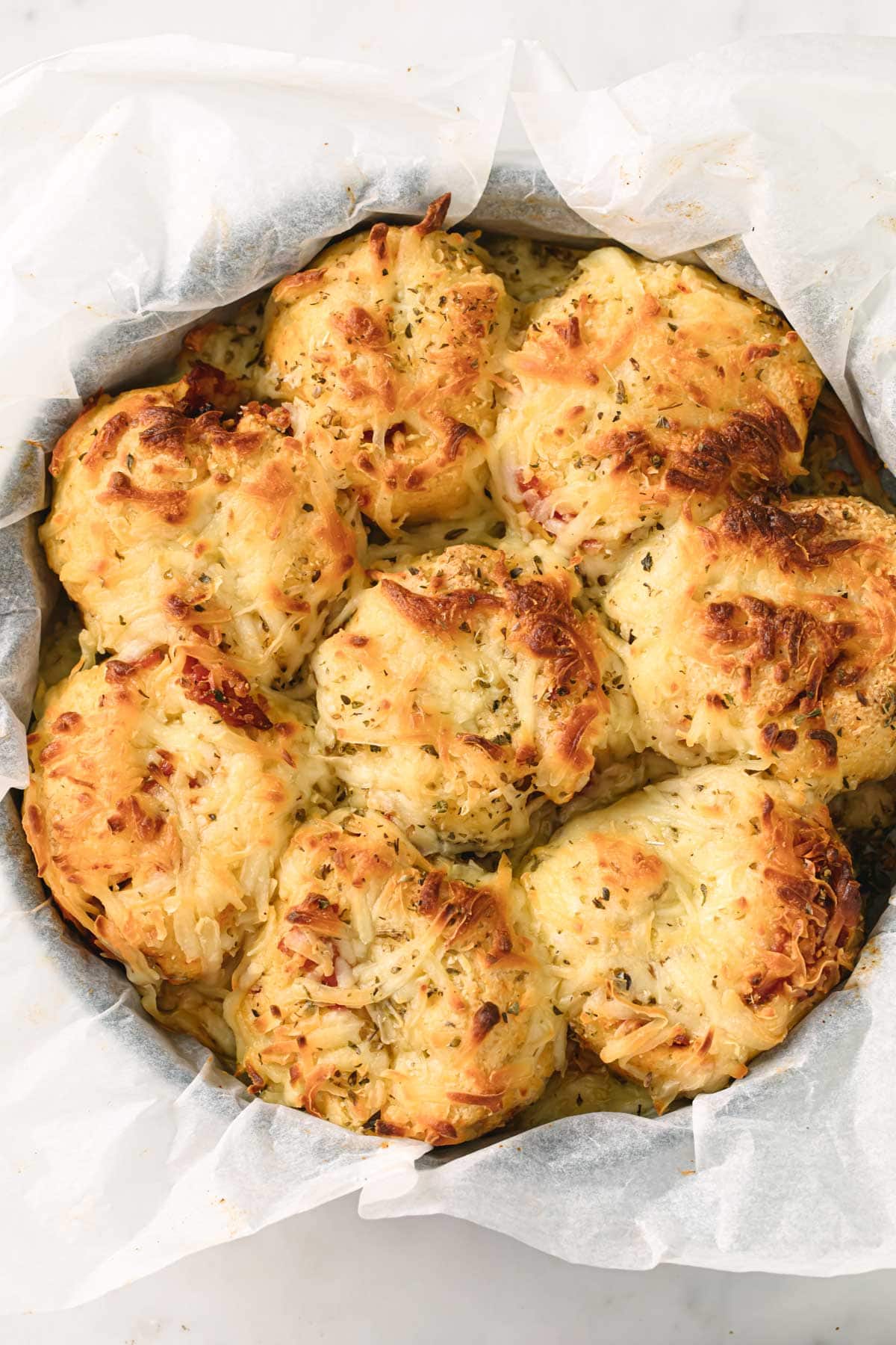 baked low carb pizza rolls in a round baking pan