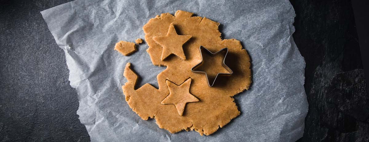 cookie dough on parchment paper with a star cookie cutter