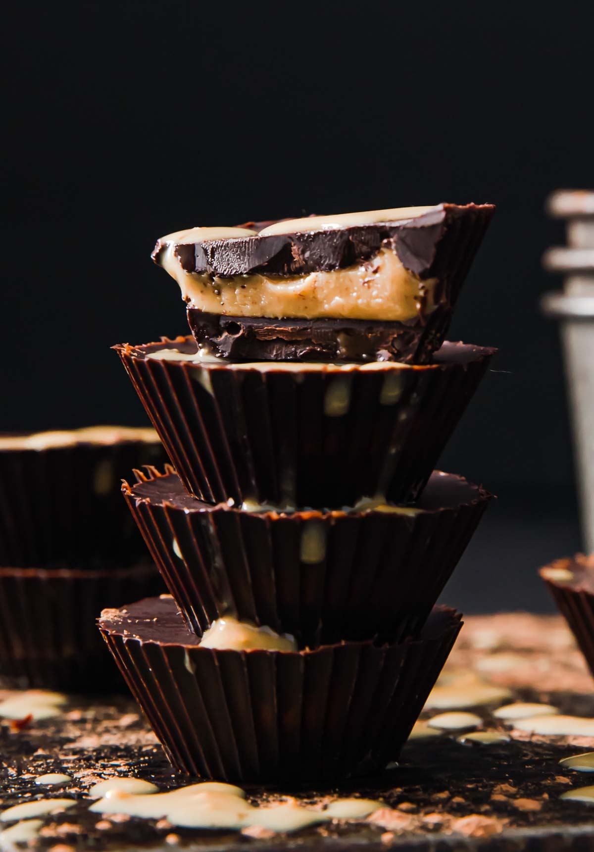 a stack of peanut butter cups, the top one is halved