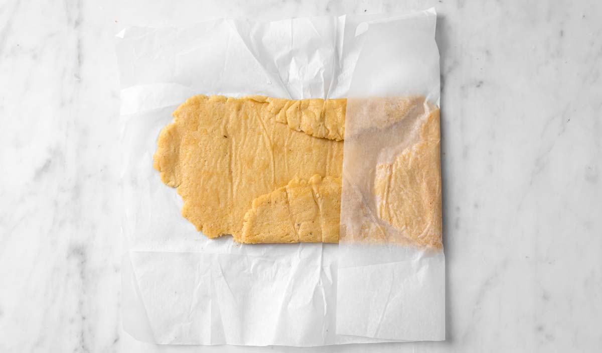 rolling the dough into a rectangle using parchment paper