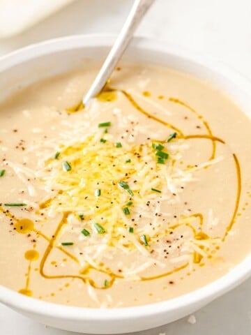 a bowl of keto cauliflower soup with a spoon