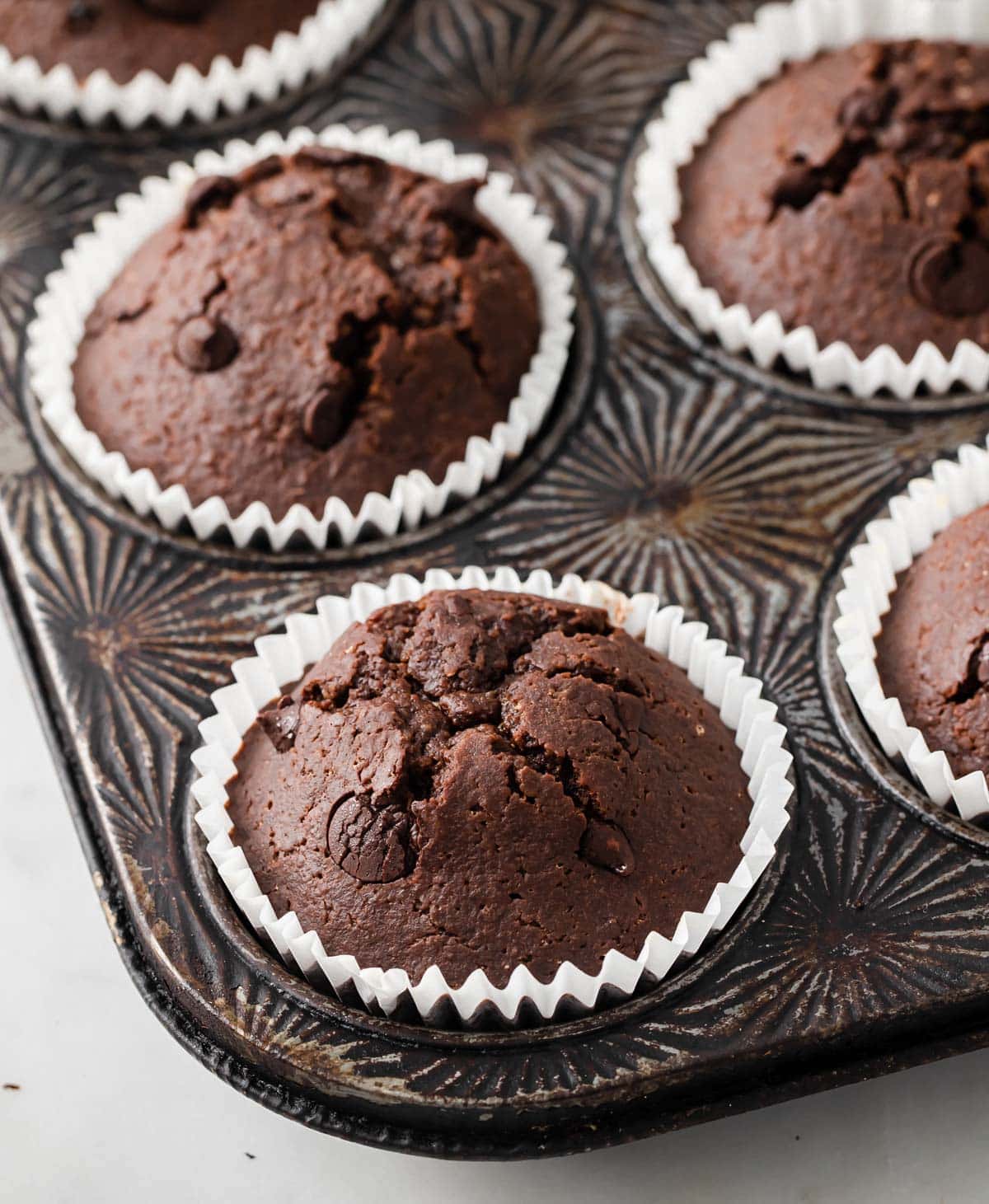 a muffin pan with keto chocolate chip muffins