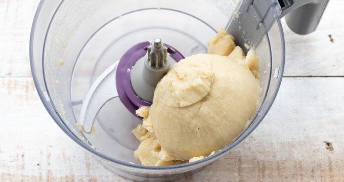 a dough ball in a food processor bowl