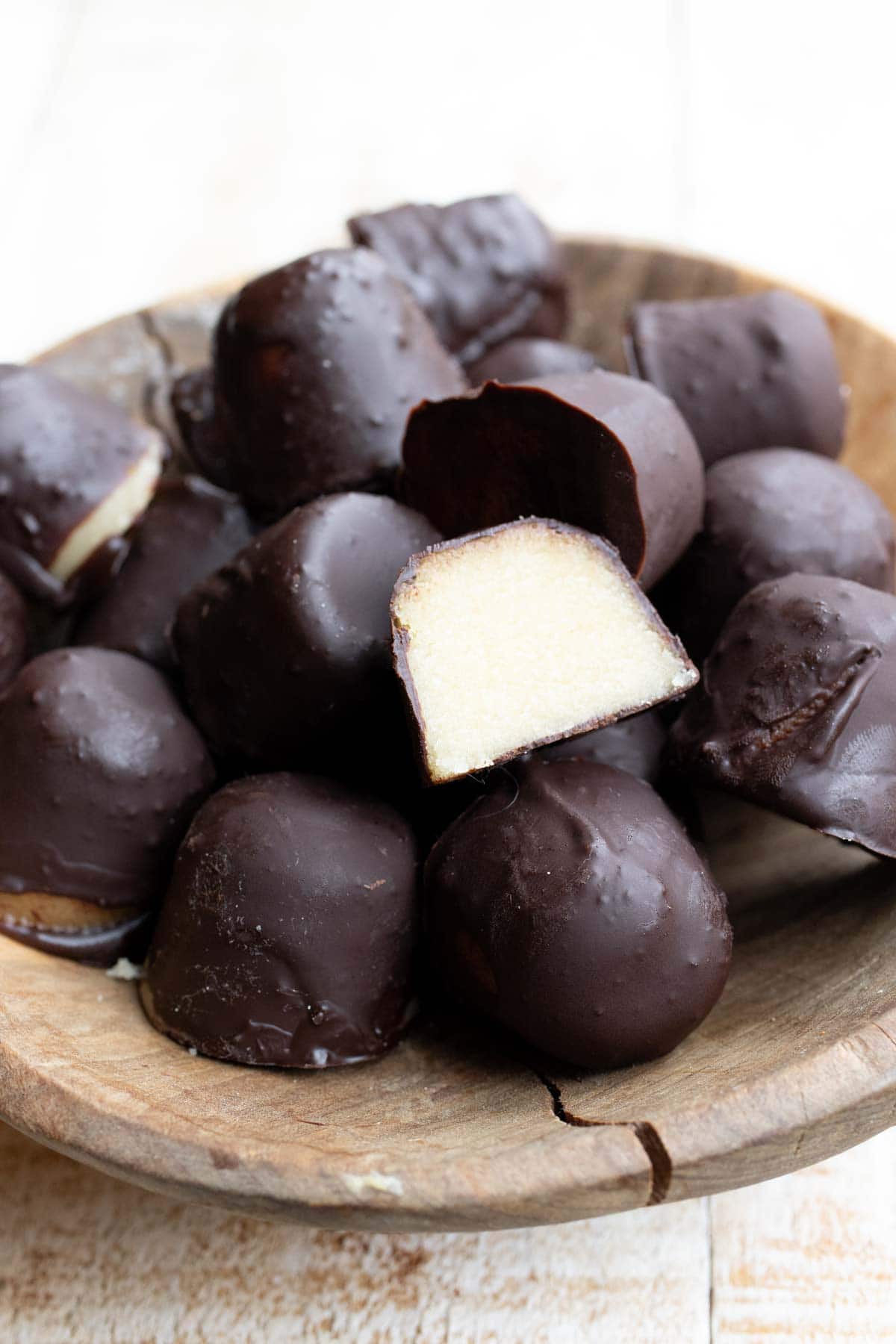 Marzipan chocolate pralines, one is cut open.