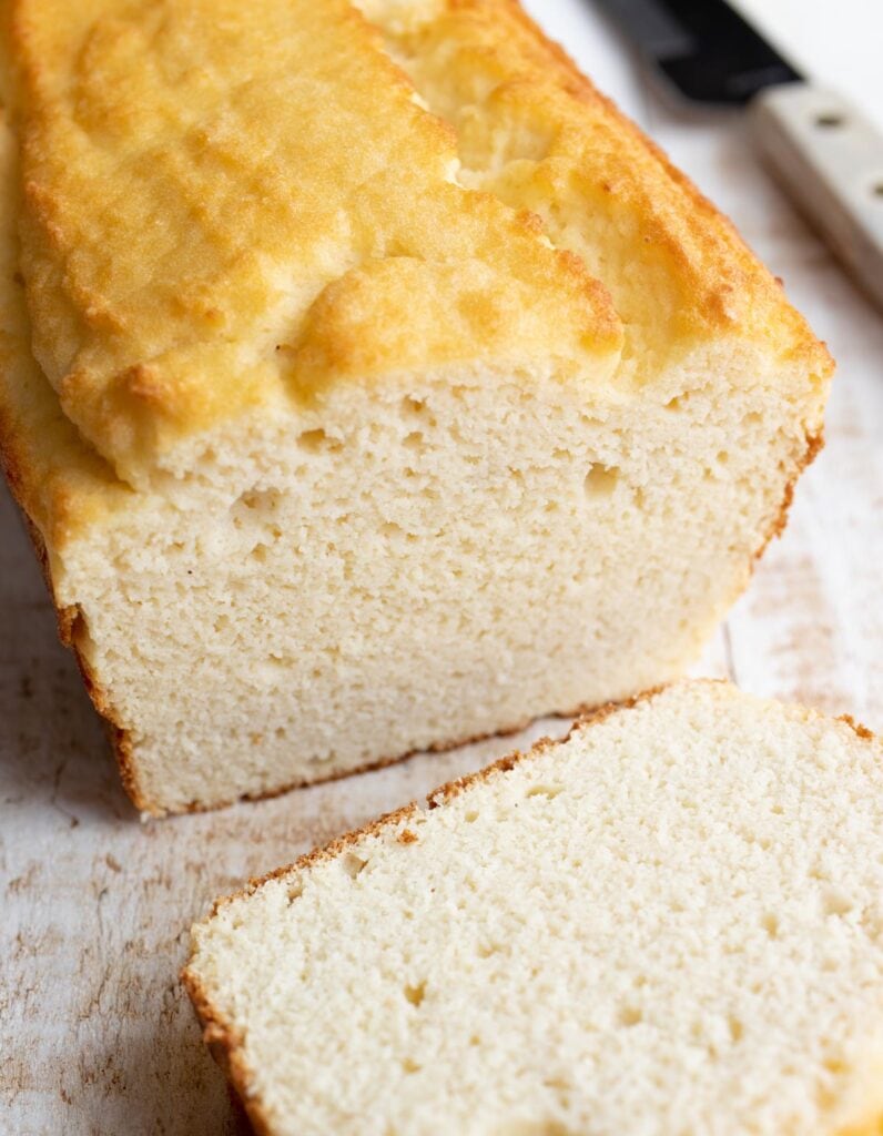 a loaf of coconut flour bread with a slice cut off
