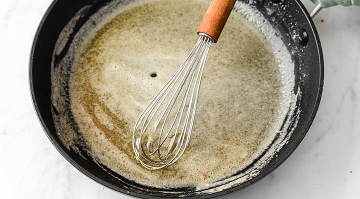 melted butter and xanthan gum in a pan with a whisk
