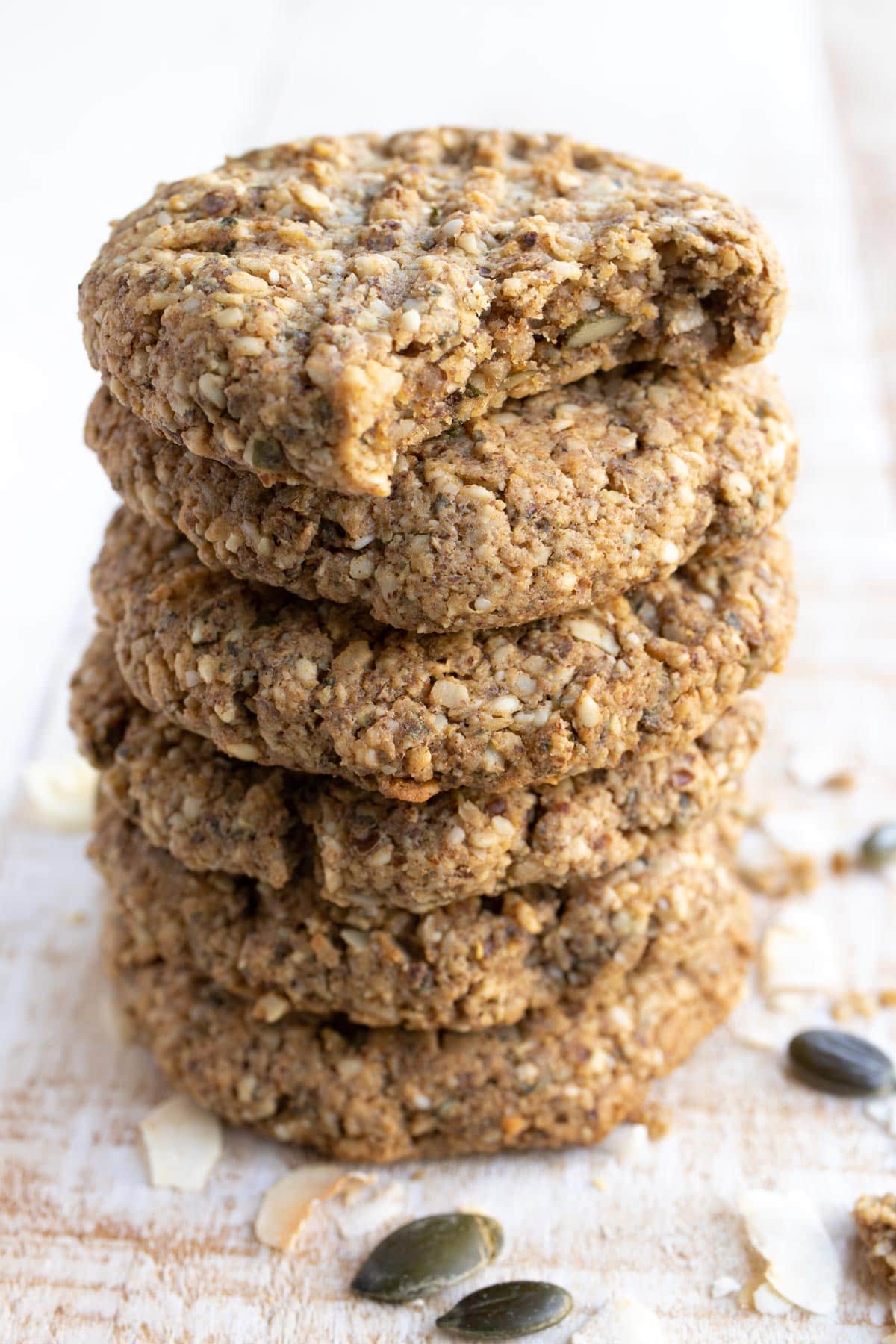 stack of keto breakfast cookies, the top one is bitten into