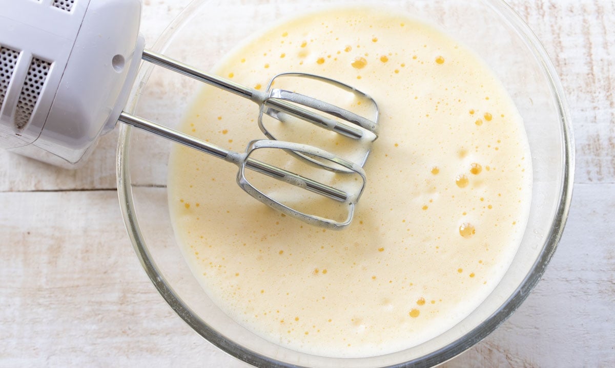 whisked frothy eggs in a bowl and a mixer
