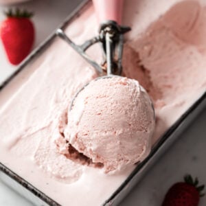 an ice cream scooper of keto strawberry ice cream