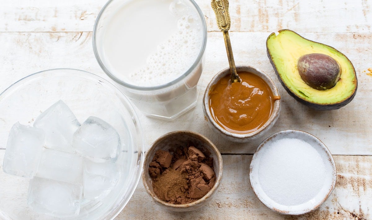 ingredients to make this recipe - avocado, peanut butter, cocoa, milk and sweetener