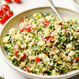 a bowl filled with keto tabbouleh made with cauliflower and a spoon