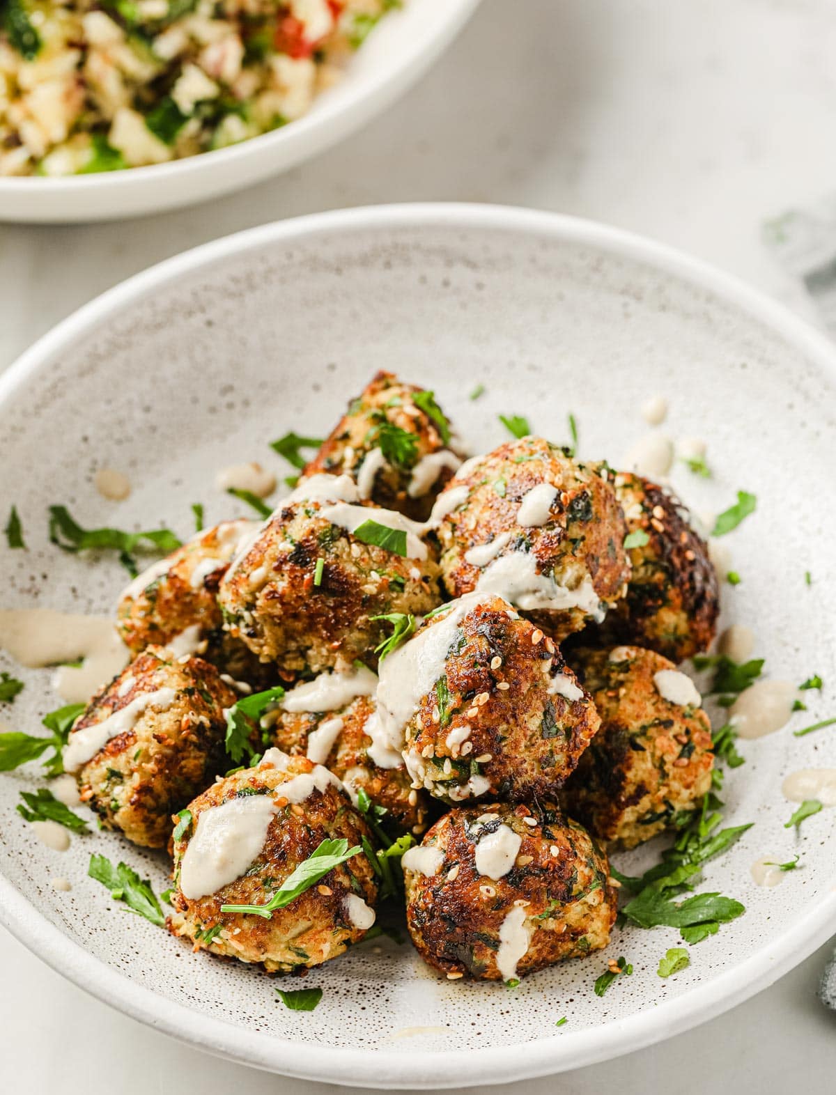a plate with keto falafel dressed with tahini sauce