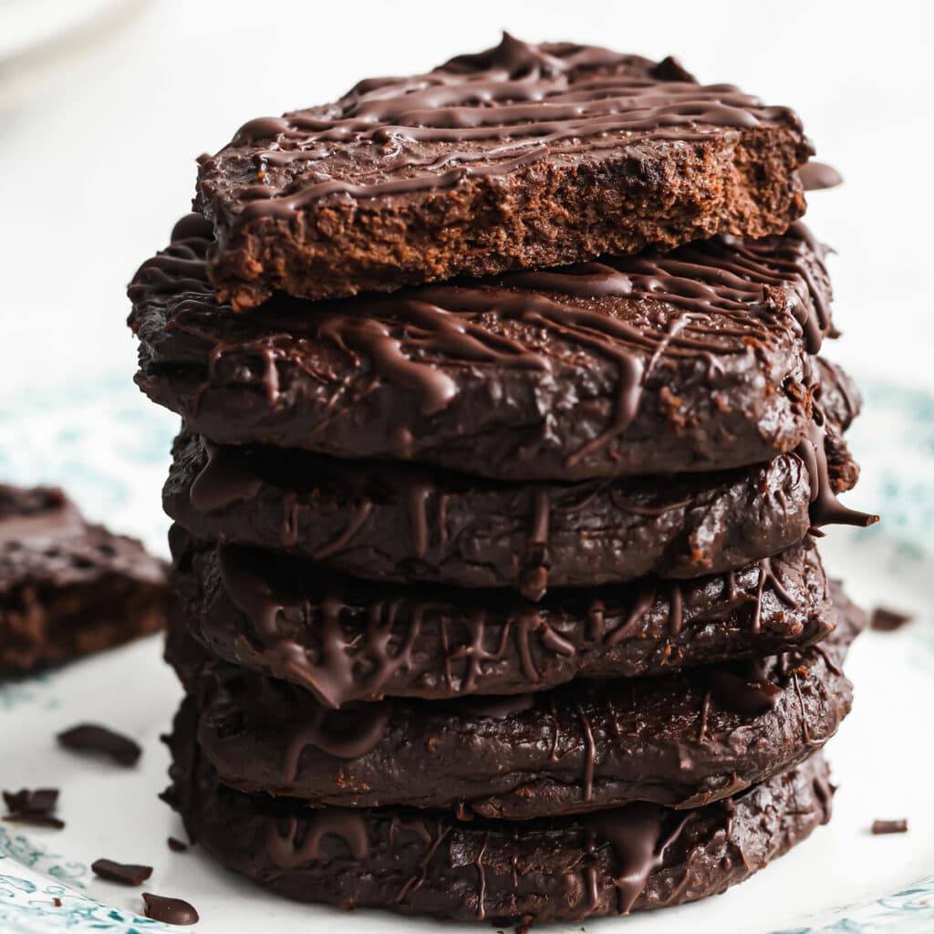 a stack of keto avocado cookies with chocolate drizzle