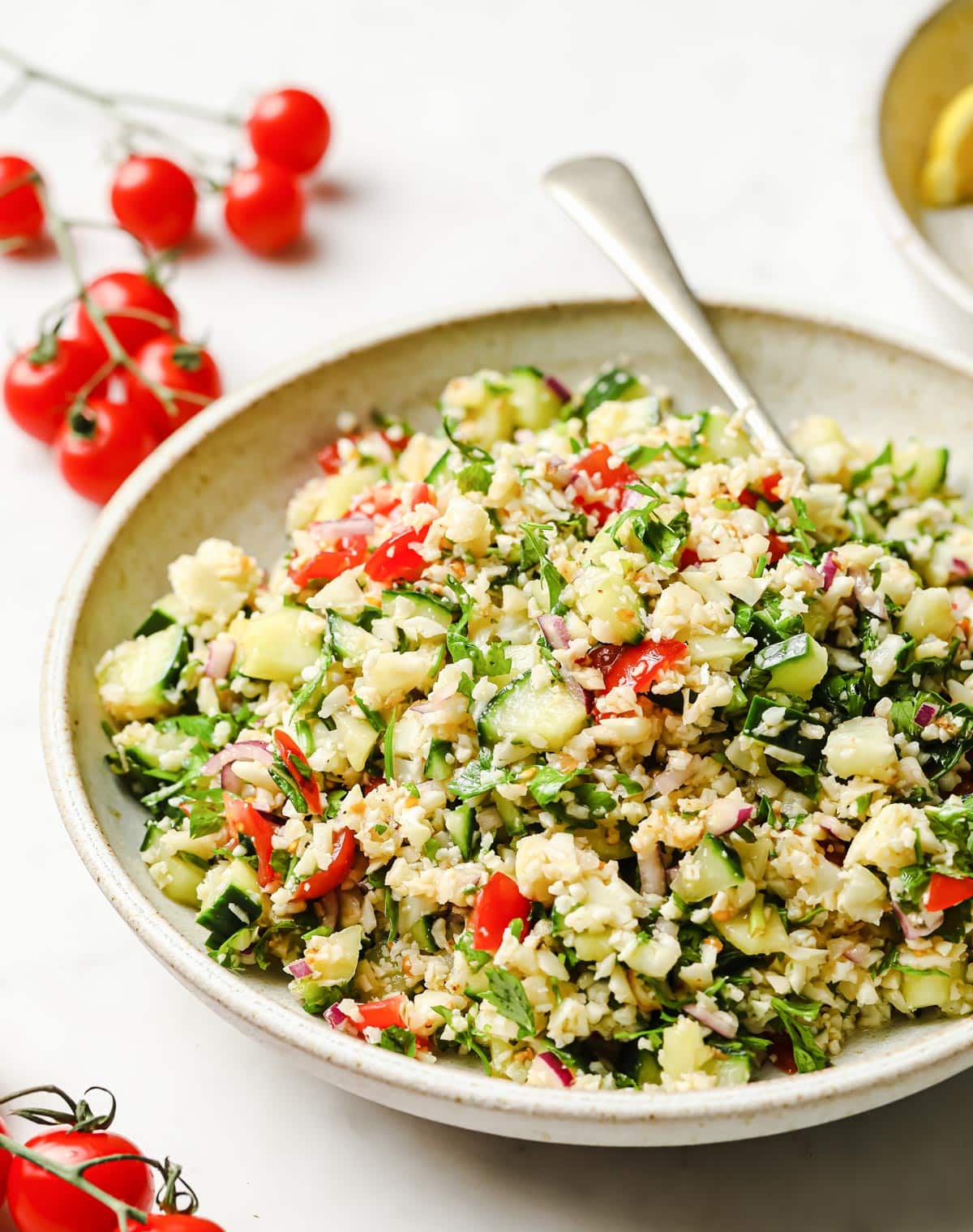 cauliflower tabbouleh in a bowl and tomatoes