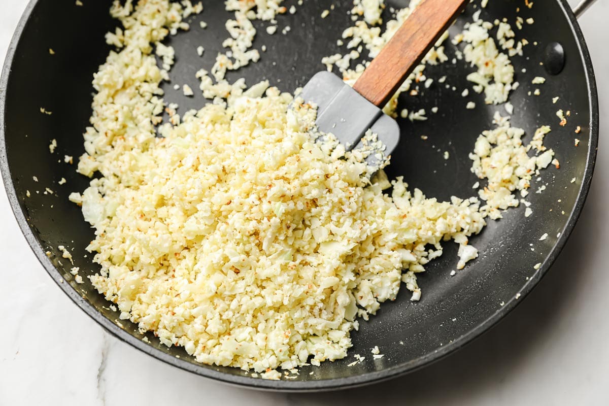 frying cauliflower rice in a pan