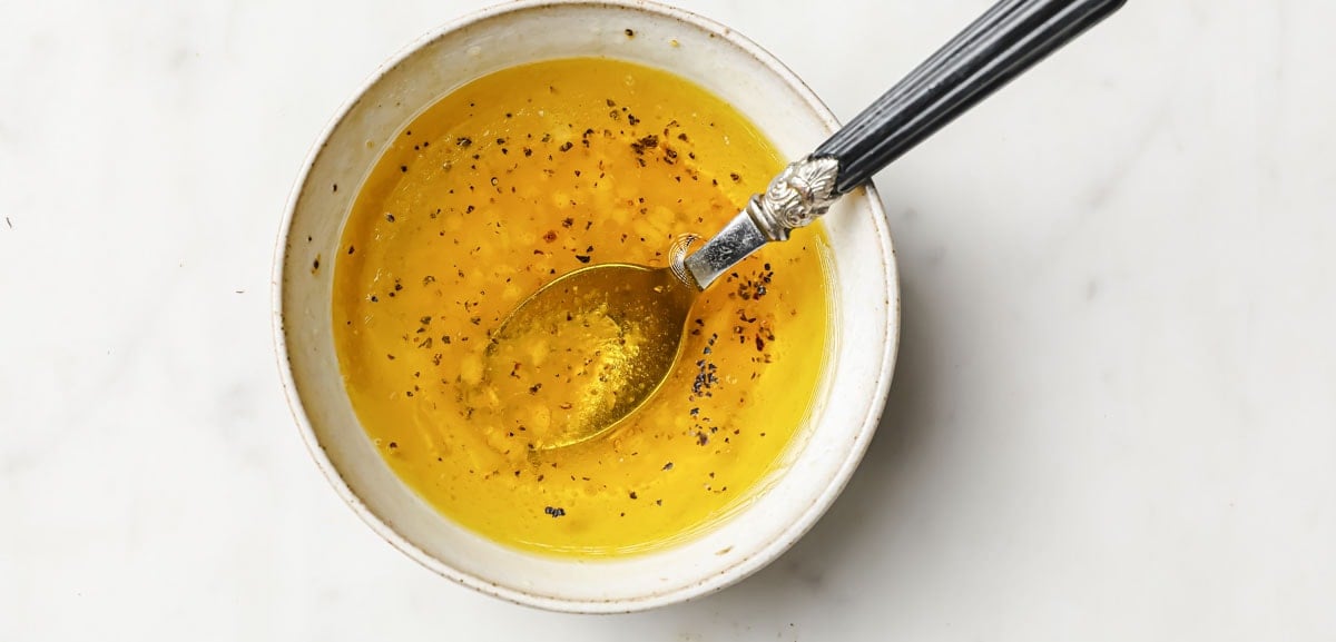 dressing in a bowl with a spoon