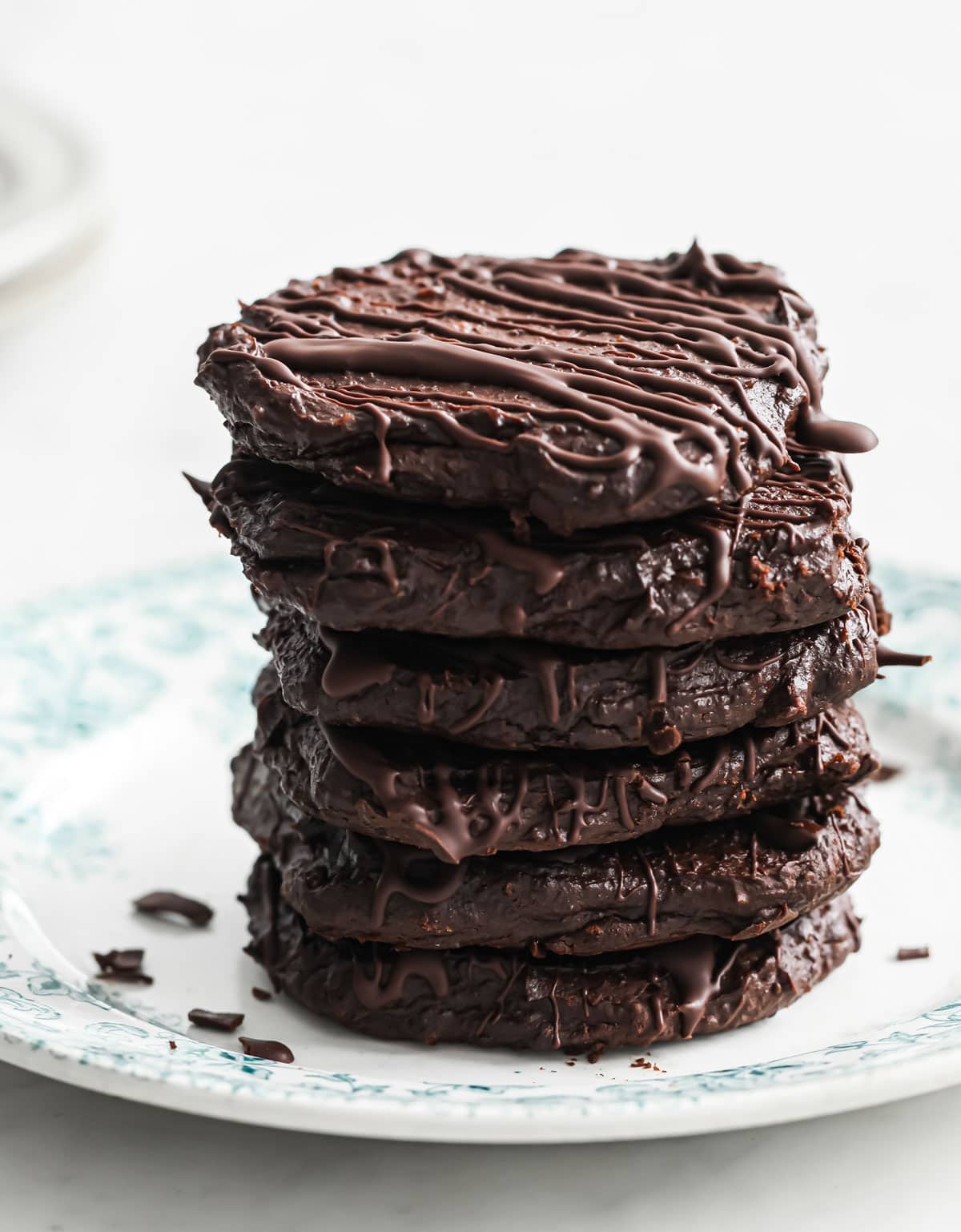 a stack of chocolate cookies with chocolate drizzle
