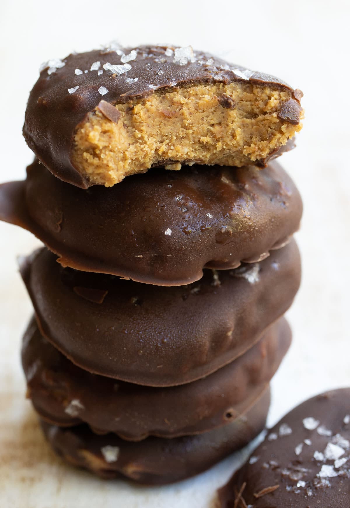 a stack of chocolate covered no bake cookies topped with sea salt